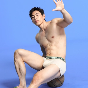 Detail of men's low-rise boxer briefs with wide branded waistband and knit texture