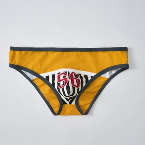Detail of yellow athletic briefs featuring breathable mesh fabric and printed number 56