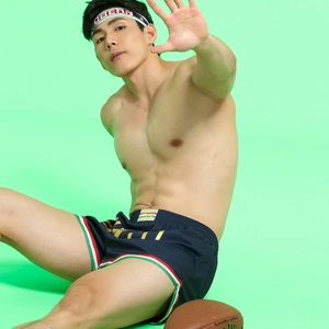 Detail of men's casual navy sports shorts with side stripes and matching headband