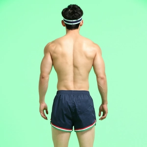 Navy blue swimming trunks detail with three-color stripe trim and back pocket design
