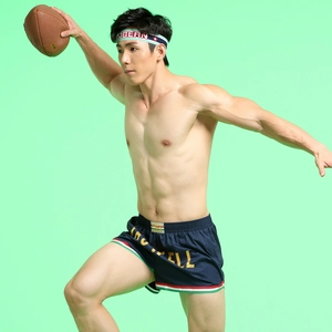 Detail of navy men's sports shorts with triple stripes and gold Hotwell print