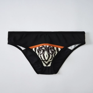 Detail of men's low-rise briefs featuring wave patterns and 66 print on black fabric