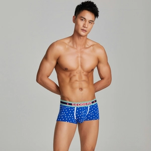Detail of men's low rise trunks with star print and elastic waistband with logo