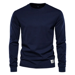 Detail of navy blue long sleeve t-shirt showing cuffs and brand label on the hem
