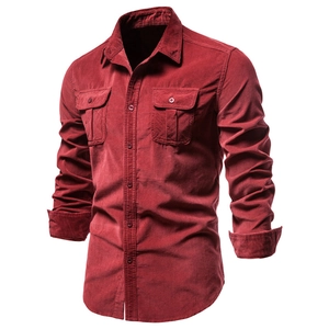 Close-up of corduroy texture, front flap pockets and button closure on men's shirt