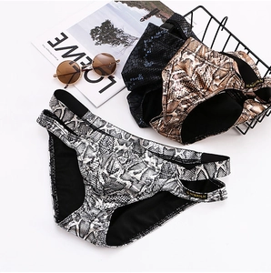 Detailed view of snake skin pattern men's briefs with side hollow double strap design