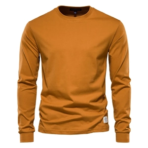 Close-up of mustard yellow men's long sleeve tee with premium knit texture and stitching