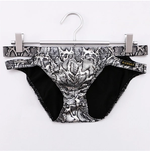 Detailed close-up of men's low-waist briefs with silver snakeskin print and U-convex pouch
