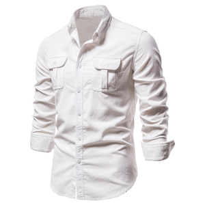 Detail view of men's white corduroy shirt with double buttoned chest pockets and sharp collar