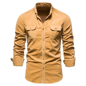 Detailed view of men's mustard corduroy shirt with utility chest pockets and button-down collar