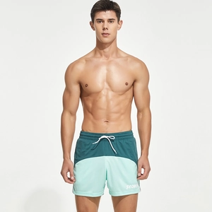 Close-up of men's two-tone running shorts with drawstring waist and logo detail