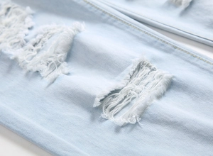 Men's light blue distressed jeans featuring street style ripped knees and raw edges