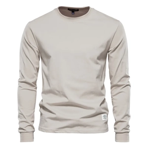 Close-up of crew neck collar and woven brand label on men's long sleeve beige cotton T-shirt