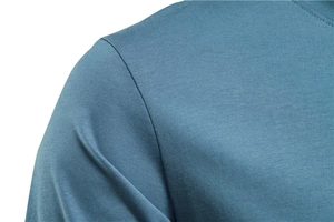 Detail view of the seamless shoulder seam and fine knit texture on a blue men's t-shirt
