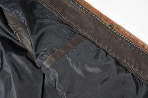 Detail view of smooth inner lining with functional interior pocket and black metal zipper