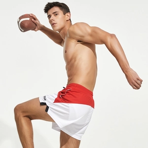 Close-up of red and white mesh shorts with elastic drawstring waist and side slit detail