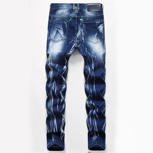 Close-up of men's blue denim jeans featuring heavy faded wash effects and back leather patch
