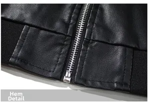 Detail of black motorcycle jacket showing premium leather texture and ribbed elastic hem