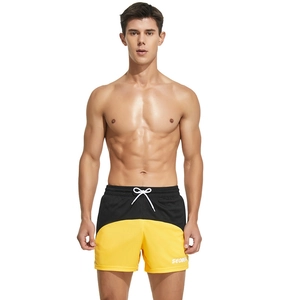 Men's athletic running shorts featuring a yellow and black color-block design and drawstring