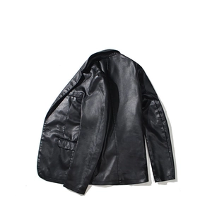 Detail view of premium black PU leather jacket blazer showing fine texture and notched lapels