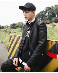 Detail of men's black faux leather biker jacket with quilted shoulder textures and stand collar