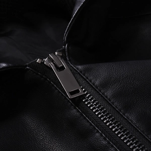 Detail of silver metal zipper and premium pebble grain texture on black leather jacket