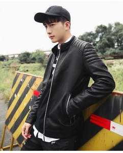 Detail of windproof stand collar and quilted shoulder seams on black PU leather jacket