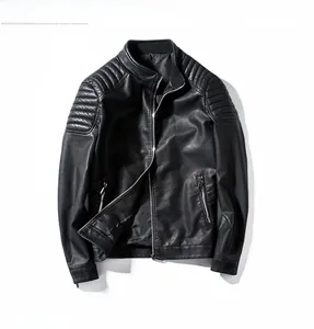 Detail of black faux leather biker jacket with quilted shoulders and silver metal zippers