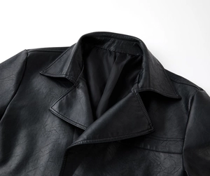 Detailed view of the matte black faux leather jacket featuring a classic blazer collar design
