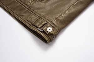 Detail shot of vintage leather jacket hem featuring metal D-ring buckle and silver button