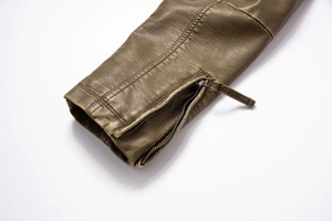Close-up of olive green vintage PU leather jacket sleeve with metallic zipper detail