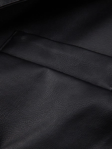 Close-up of premium black lychee-grain PU leather texture and fine stitching detail