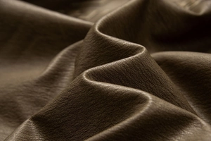 Macro shot of dark brown vintage PU leather material with thick grain texture