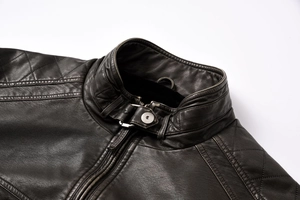 Detailed view of brown PU leather jacket with quilted shoulder stitching and metal zipper