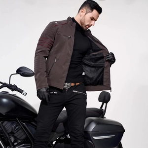 Men's brown faux leather biker jacket with quilted shoulders on a motorcycle