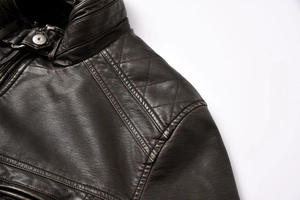 Detail of vintage brown PU leather jacket featuring diamond quilted stitching on shoulders