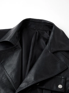 Detail of classic black leather trench coat notch lapel with premium silver metal button