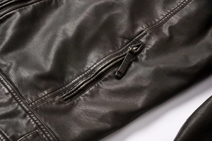 Close-up of brown PU leather jacket with premium litchi texture and zipper pocket