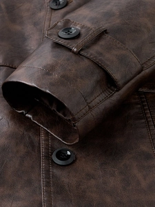 Detail shot of men's brown PU leather coat sleeve cuffs and high-quality stitching