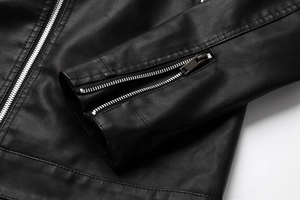 Detailed macro view of black faux leather jacket cuff with silver metal zipper detail