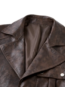 Detail of dark brown leather jacket featuring retro lapels and metallic buttons