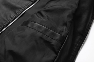 Close-up detail of the inner lining and pocket design of a black PU leather jacket