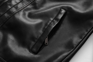 Detailed close-up of a black PU leather jacket featuring a zipper pocket and fine stitching