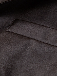 Close-up of litchi grain texture and neat stitching on a men's casual PU leather jacket