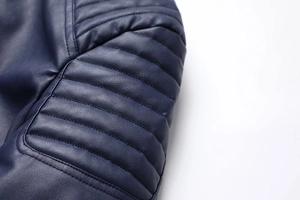 Macro shot of horizontal quilted shoulder detail on navy blue PU leather jacket