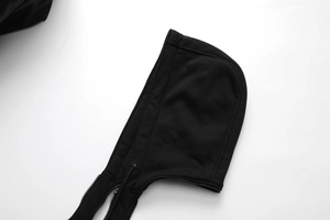 Close-up detail of a black hooded PU leather jacket with metal zipper and drawstrings