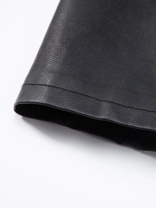 Detailed macro view showing the premium pebbled texture and fine stitching of black PU leather