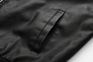 Close-up of black PU leather jacket showing side pocket and lychee texture detail