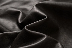 Detailed close-up of premium black lychee texture PU leather with soft matte finish