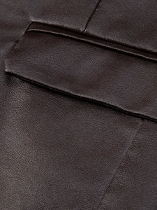 Detail of dark brown PU leather jacket showing premium grain texture and precise stitching